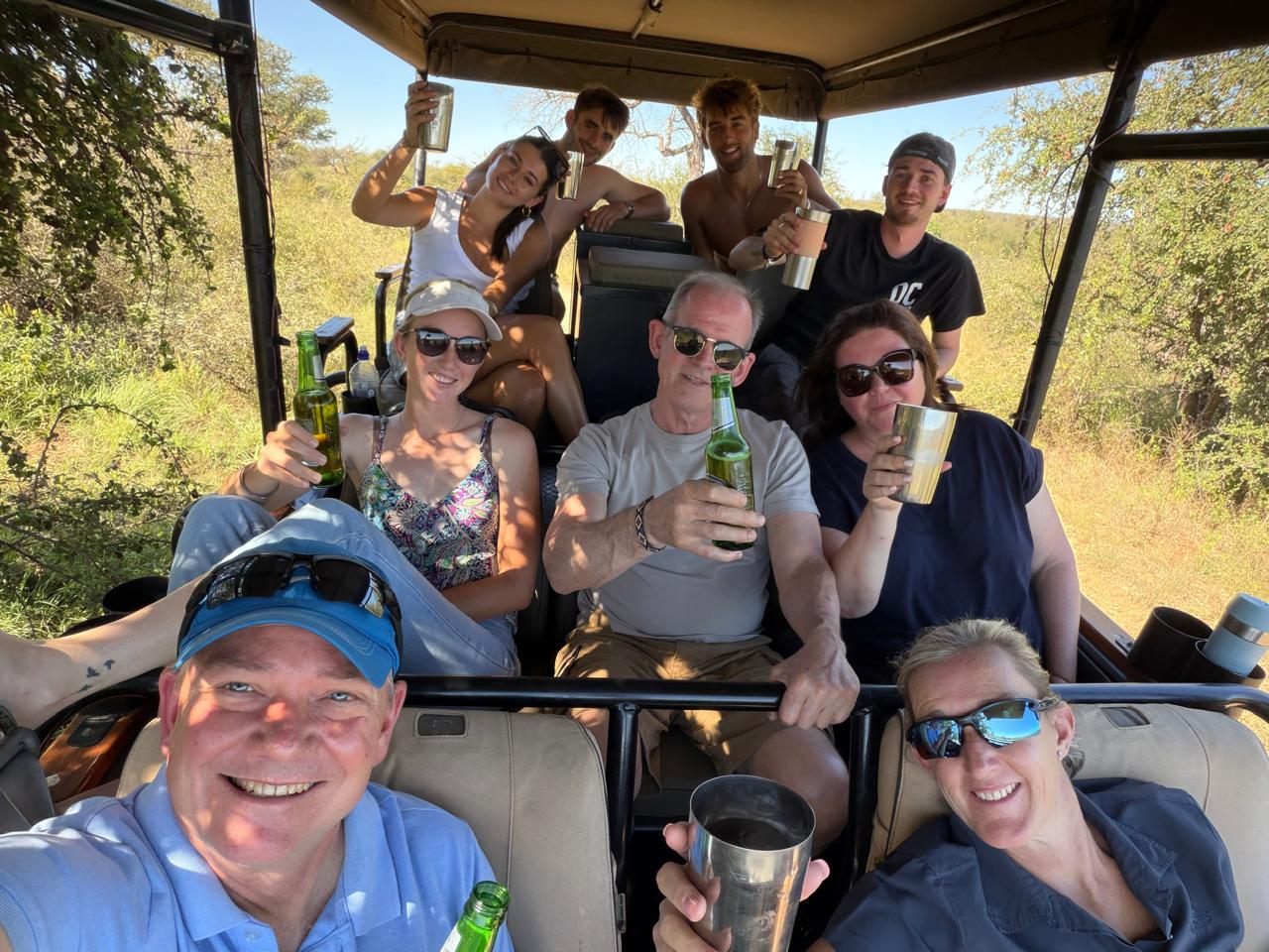Travellers smiling together on a safari game drive